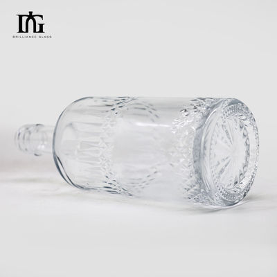 Η επιφάνεια του οξέος στρογγυλή 550 ml 700 ml οινοπνευματώδη ποτά γυάλινο μπουκάλι για ανθρακούχα ποτά